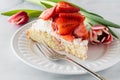 Close up of a slice of strawberry shortcake on a white plate ready for eating. Royalty Free Stock Photo