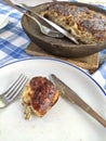 Serbian cheese pie in a earthenware and plate with cutlery. Royalty Free Stock Photo