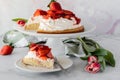 Close up of a slice of strawberry shortcake with the full cake in behind Royalty Free Stock Photo