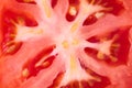 Close up of a slice of tomato, raw red fruit macro, abstract background, pattern Royalty Free Stock Photo