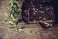 Close-up of the sliced brown bread at the cutting board on the wooden table with black background. Top view Royalty Free Stock Photo