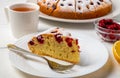 Close-up of a sliced cherry pie, a slice of pie on a plate, and lemon tea Royalty Free Stock Photo