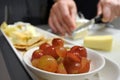 Close up of sliced grape fruit in a bowl served with cheese and crackers