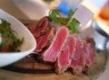 Close up Sliced grilled rare beef steak served on wooden board, Barbecue, bbq meat beef tenderloin, copy space on blank flag, food Royalty Free Stock Photo