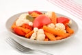 Close up of sliced juicy pickled vegetables (paprika, cauliflower, carrot and celery) in a plate