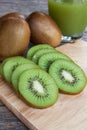 Close up sliced kiwi and kiwi juice on wood booard