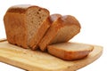 Close-up of sliced loaf of rye bread on cutting board on white background Royalty Free Stock Photo