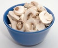 Close up sliced mushrooms in blue bowl