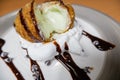 Fried ice cream with chocolate syrup and cream on plate Royalty Free Stock Photo