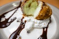 Fried ice cream with chocolate syrup and cream on plate Royalty Free Stock Photo