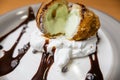 Fried ice cream with chocolate syrup and cream on plate Royalty Free Stock Photo