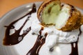 Fried ice cream with chocolate syrup and cream on plate Royalty Free Stock Photo