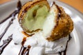 Fried ice cream with chocolate syrup and cream on plate Royalty Free Stock Photo