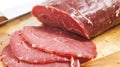 A close up of a sliced piece of meat on top of wood, AI Royalty Free Stock Photo