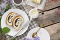 Close up of sliced poppy seed roll on white plate