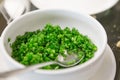 Close up of Sliced spring onion in a white cup