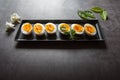 Close up of slices of boiled eggs arranged on a black tray Royalty Free Stock Photo