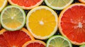 a close up of slices of citrus fruit with water droplets on them