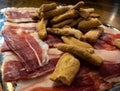 Slices of dried pork also known as Jamon Serrano with crusty bread toast Spanish Royalty Free Stock Photo