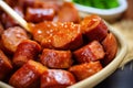 Close up of slices of German sausage with curry sauce called \'Currywurst