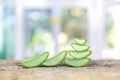 Close-up slices of green fresh aloe vera plant or stalk or leaves stack or stacked with water dropping