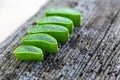 Close-up slices of green fresh aloe vera plant or stalk or leaves stack or stacked with water dropping