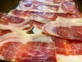 Slices spanish dried pork also known as Jamon Serrano. Typical tapa Iberian ham Royalty Free Stock Photo