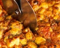 Close-up of slicing an Italian pizza. Traditional food from Palermo, Sicily, Italy. Ingredients Tomato sauce, anchovy, onion, Royalty Free Stock Photo