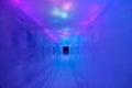 CLOSE UP: Slick corridor made of ice is illuminated by multi-coloured lights Royalty Free Stock Photo