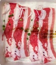Close up. Slide raw wagyu beef on a red and white plate. uncooked beef, Japanese style for meat grill.
