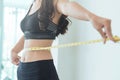 Close up of Slim Asian woman waist with measuring tape. copy spa