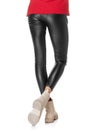 Close-up slim female legs in black leggings isolated on white background Royalty Free Stock Photo