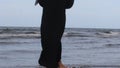 Close up slim legs woman walking barefoot on wet sand and sea waves lightly touching feet enjoying summer trip to tropical