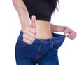 Close up slim woman in old jeans showing thumbs up isolated on w Royalty Free Stock Photo