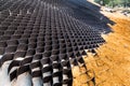 Close up of slope erosion control with grids and earth on steep slope Royalty Free Stock Photo