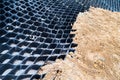 Close up on slope erosion control grids on steep slope. Royalty Free Stock Photo