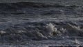 Close-up of slow waves on sea. Creative. Beautiful waves in slow motion on stone shore. Stone beach with beautiful waves Royalty Free Stock Photo