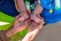 Close-up of small baby feet are holding by grandmother`s hands, soft focus Royalty Free Stock Photo