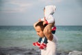 Close up of small baby girl in hood sitting on father`s shoulders on the sky background Royalty Free Stock Photo