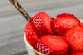 Close up - small bowl with spoon, full of strawberries cut into Royalty Free Stock Photo