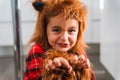 Close up of a small boy dressed as werewolf gesturing while scaring the camera during Halloween celebration