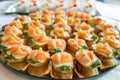 Close up of small canapes arranged on a mirror plate over light background Royalty Free Stock Photo