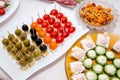 Close up of small canapes arranged on a plate over light background Royalty Free Stock Photo