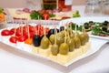 Close up of small canapes arranged on a plate over light background Royalty Free Stock Photo