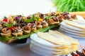 Close up of small canapes arranged on a plate over light background Royalty Free Stock Photo