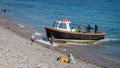 Close up of small fishing boat beaching on the shingle on Beer beach, Devon, UK