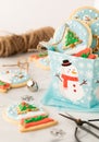 Close up of a small gift box filled with homemade snow globe cookies.