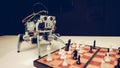 Close up. Small Gray Robot Playing Chess on Table