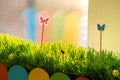 Close up of small green grass with special cute toys small butterflies. Concept of beautiful plants with decoration