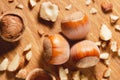 Close-up of a small group of unshelled hazelnuts and many pieces of shelled hazelnut kernels on a wooden background. Top view Royalty Free Stock Photo